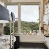 Bedroom with Kali Duo Bunk Bed Sofa, Boll & Branch organic bedding, Cali Bamboo flooring, Andersen 100 series windows, Meural Winslow digital canvas, custom peg board wall system with Richlite shelving built by Sean Sliger and Plumen 003 dimmable LED pendant light.